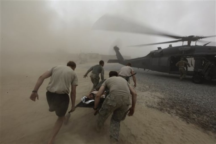 During a rescue mission by a team from a U.S. Air Force Expeditionary Rescue Squadron, army medics carry a wounded Afghan Army soldier to an evacuation helicopter, in Kandahar province, southern Afghanistan on Monday. 